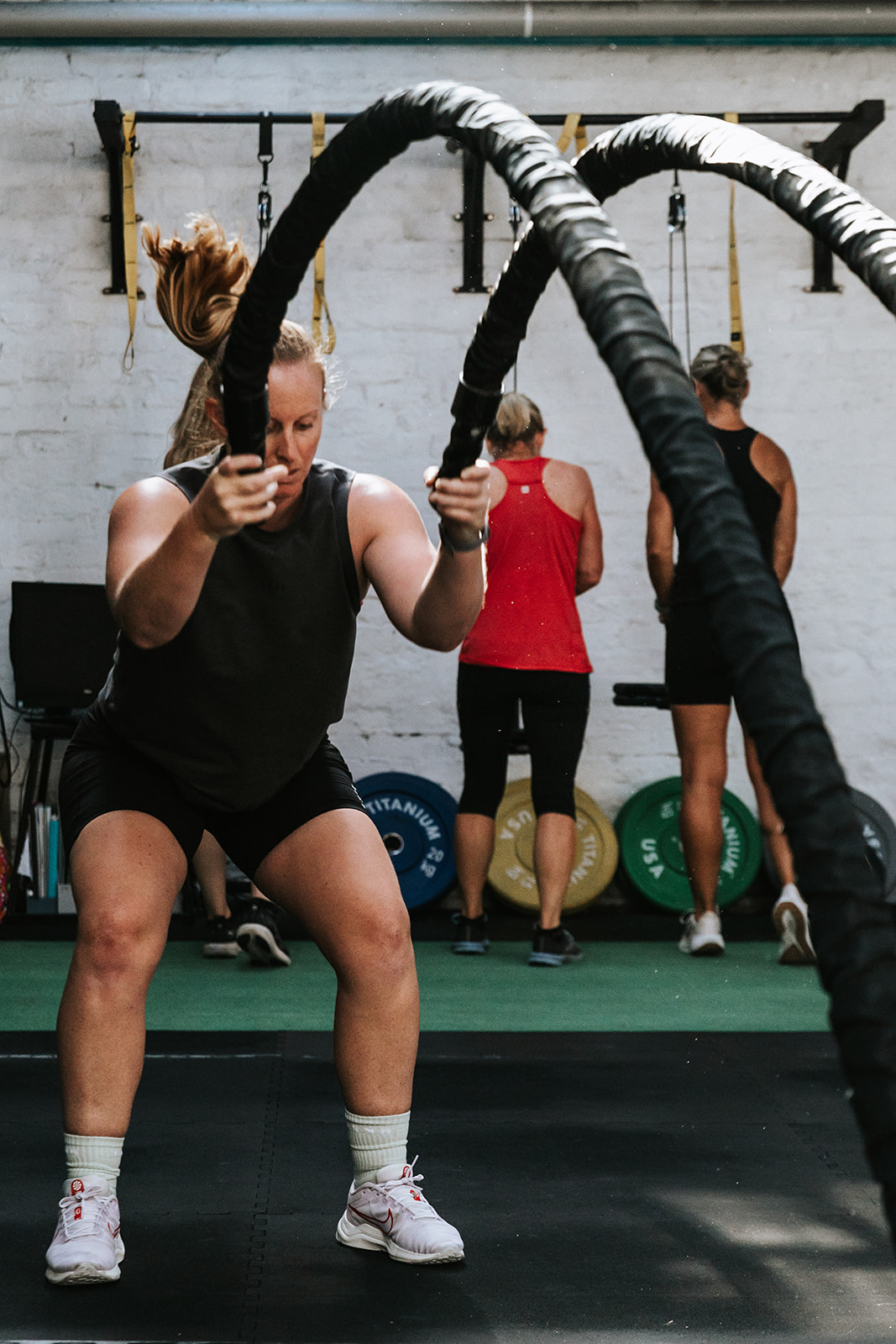 Member working through battle rope intervals
